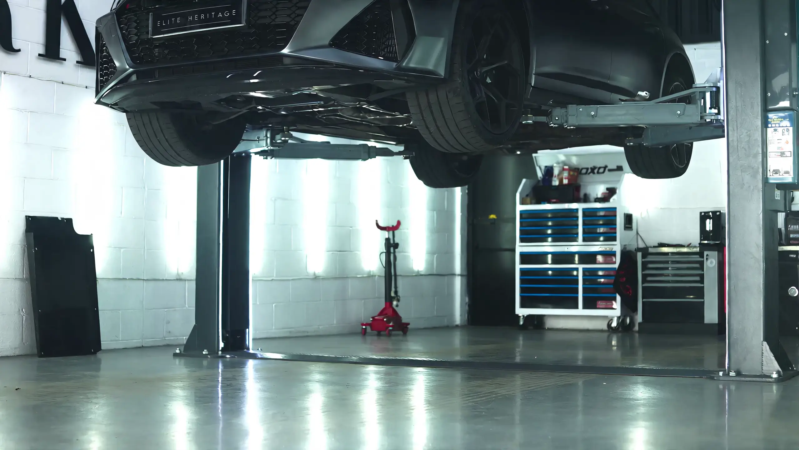 An Audi supported on the raised lift in the Elite Heritage workshop