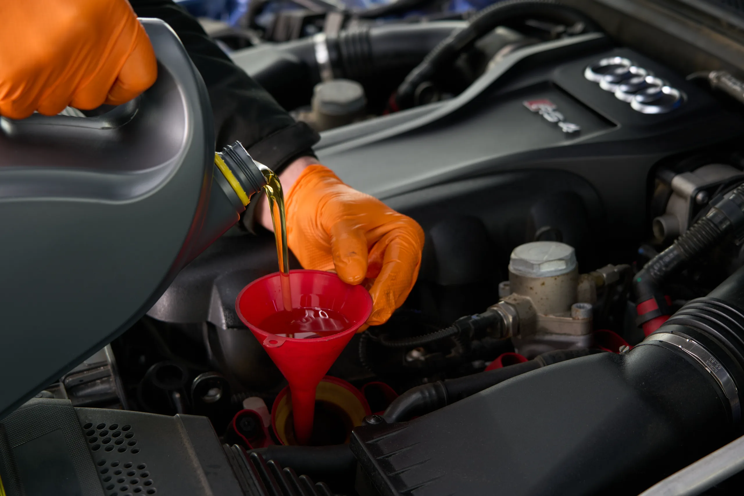Fresh engine oil being added during an Autoworks service